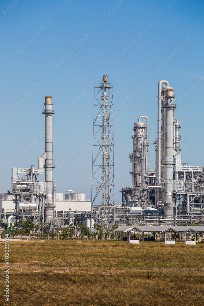 Refinery tower fo oil and refinery plant with blue sky - Landscape view Refinery tower fo oil and refinery plant with blue sky - Landscape view