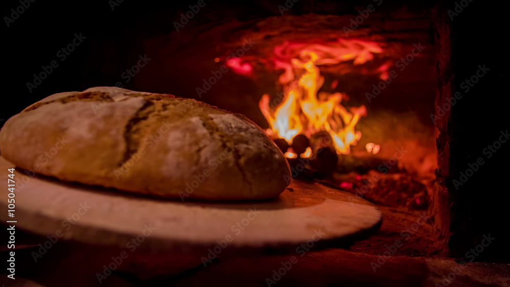 Freshly baked bread going out of the bread oven