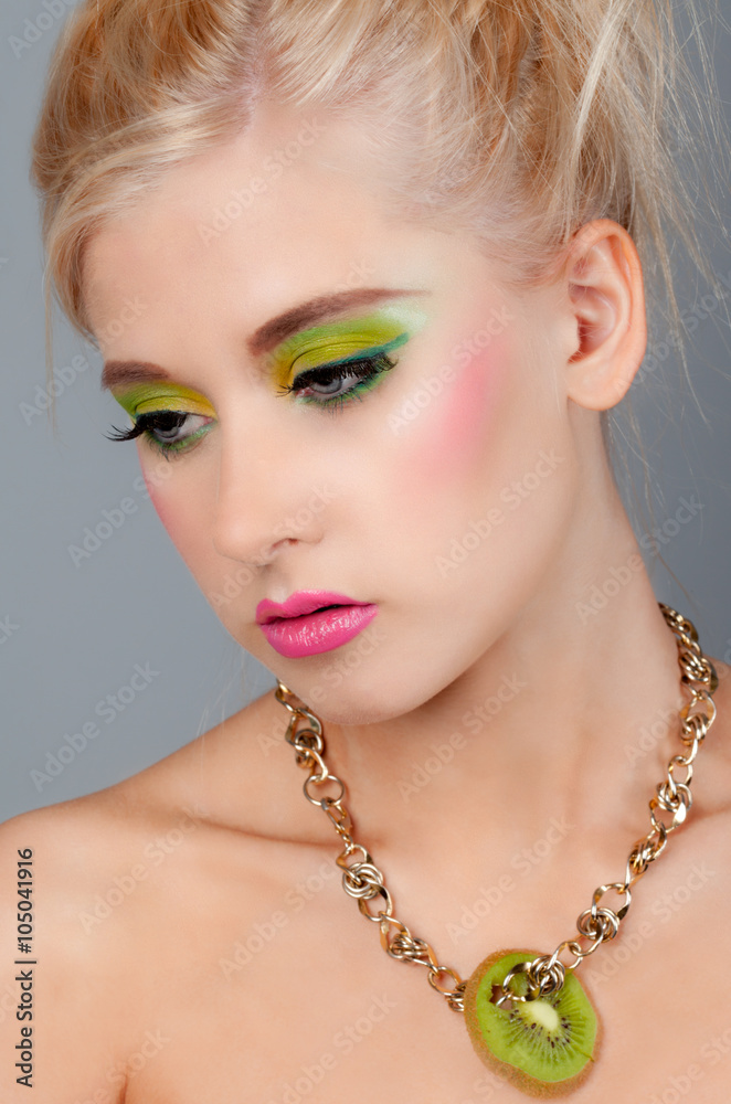 Pretty Teen in Colorful Makeup With Kiwi