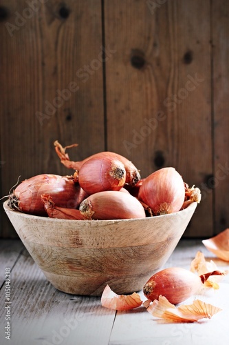 Shallot on a rustic wooden table.Selective focus