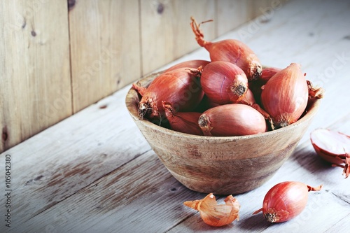 Shallot on a rustic wooden table.Selective focus photo