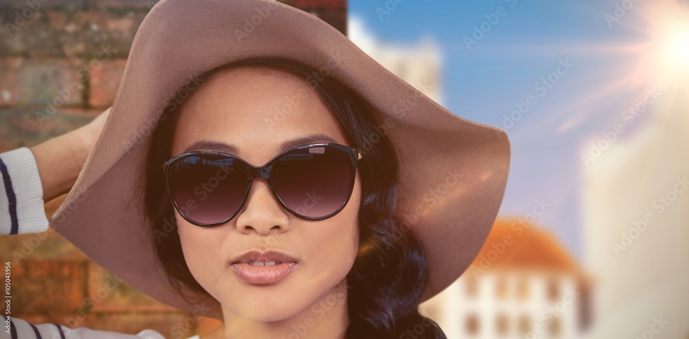 Composite image of asian woman with hat and sunglasse Composite image of asian woman with hat and sunglasse