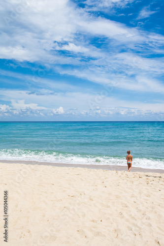 Little girl walking on the beach, beach vacation