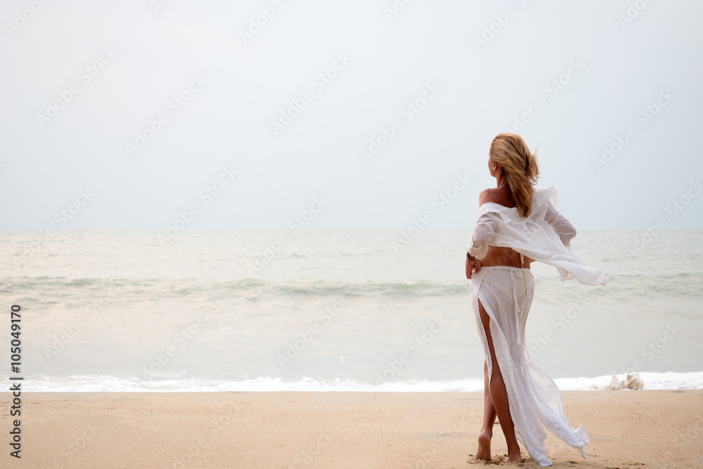 Woman with sarong on the beach Woman with sarong on the beach