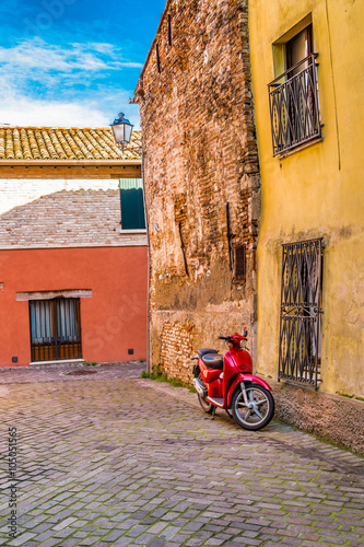 red scooter in narrow street