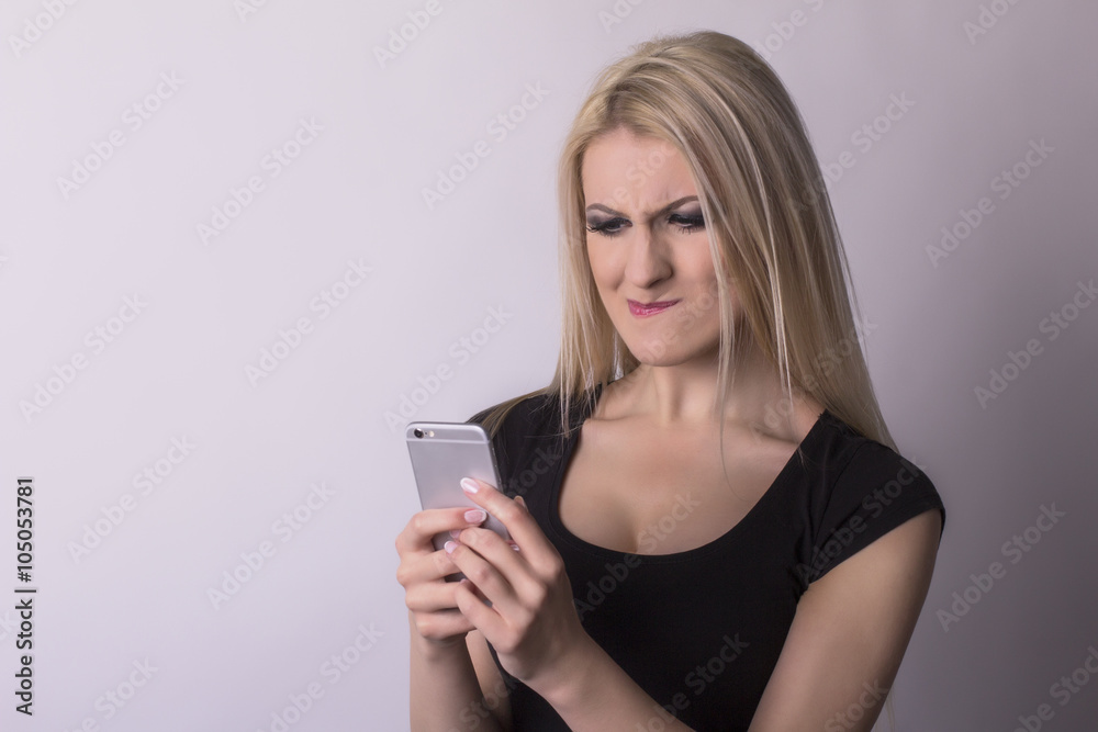 Nervous woman looking on mobile phone