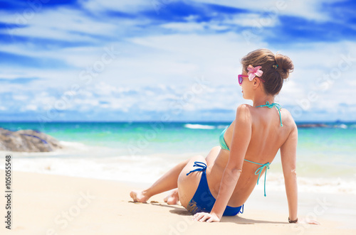 beautiful woman in blue bikini enjoying her day at beach