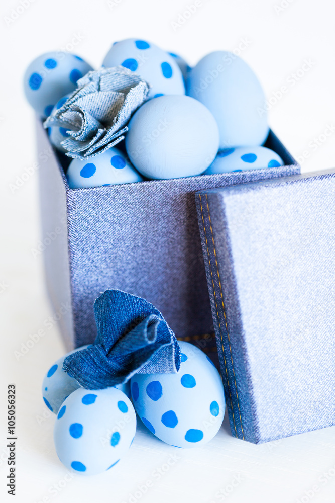 Easter eggs in a denim box. - obrazy, fototapety, plakaty 