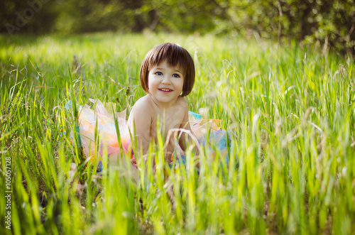 little girl sitting in the grass