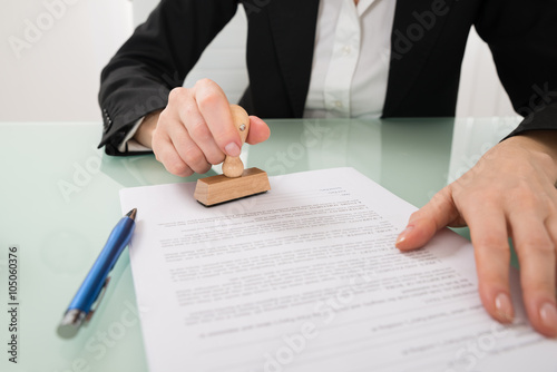 Businesswoman Hand Using Stamper On Document