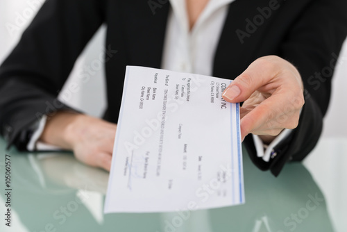 Businesswoman Hand Giving Cheque photo