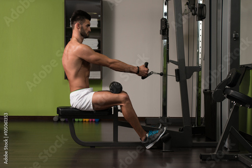 Young Man Doing Heavy Weight Exercise For Back