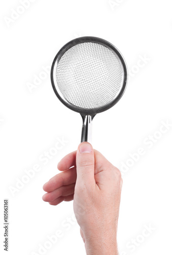 metal sieve in a human hand isolated on white background © REDSTARSTUDIO