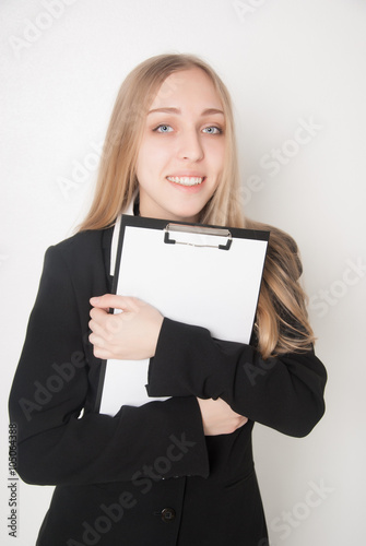 Smiling young woman holding a blank clipboard (isolated on white