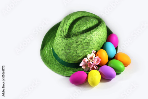 Green straw hat with easter colorful eggs 