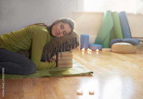 Attractive mixed race woman doing restorative yoga photo