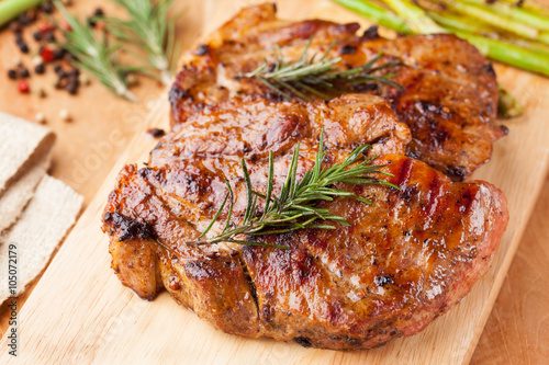 pork chop with rosemary on wooden board