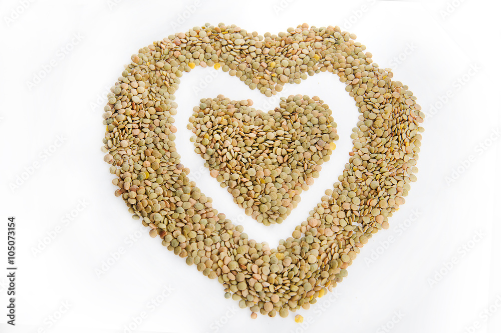 Green lentils in a heart shape, isolated on a white background Green lentils in a heart shape, isolated on a white background
