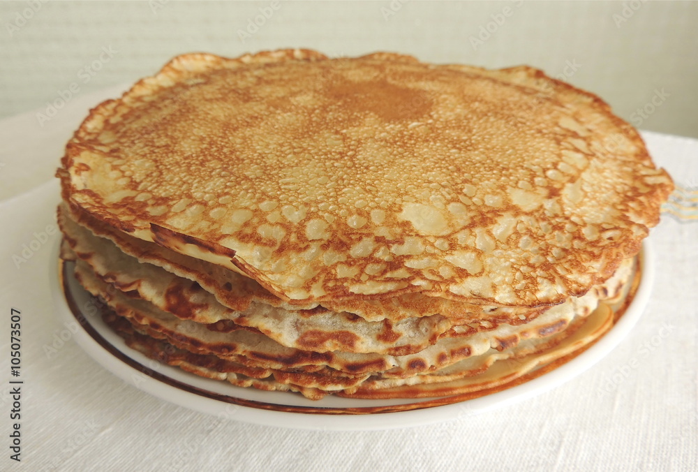Shrove Tuesday pancakes on the table. Fresh baked pancakes on the plate. Shrove Tuesday pancakes on the table. Fresh baked pancakes on the plate.