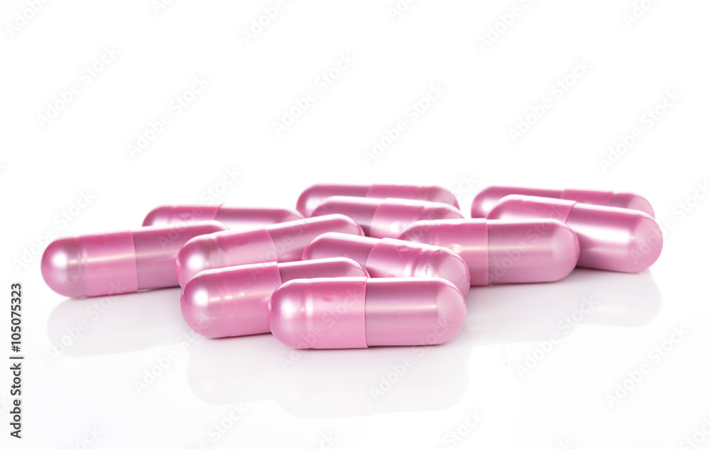 pink pill capsules on white background pink pill capsules on white background
