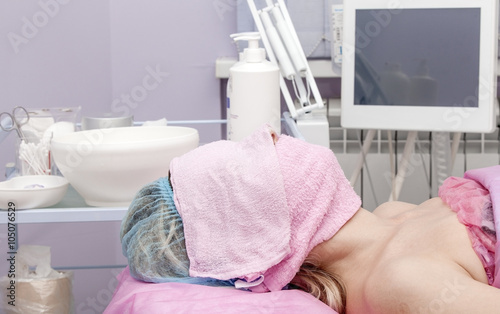 Woman in a beauty salon with a towel on his face