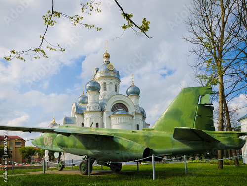 War and Peace allegory - church and Afghan War time plane in Belarus  photo