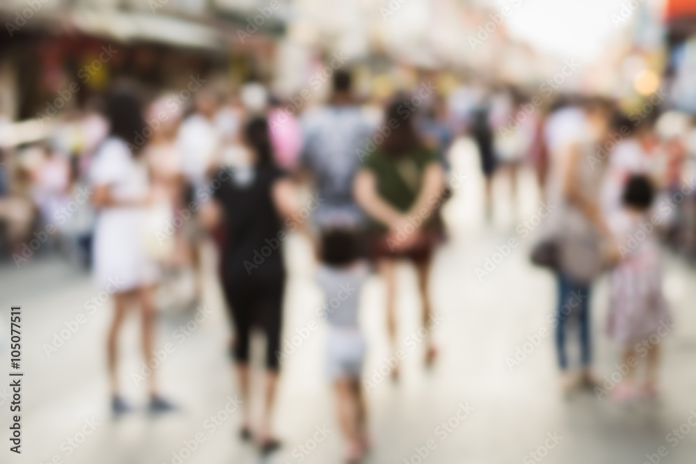 Blurred people walking on the street