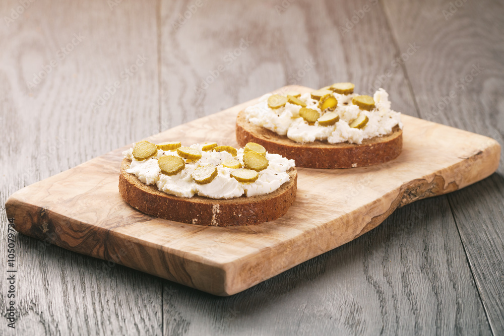 sandwiches with rye bread, cream cheese and marinated cucumbers, vintage toned sandwiches with rye bread, cream cheese and marinated cucumbers, vintage toned