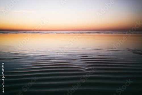 calm sunset over baltic sea beach  shallow focus