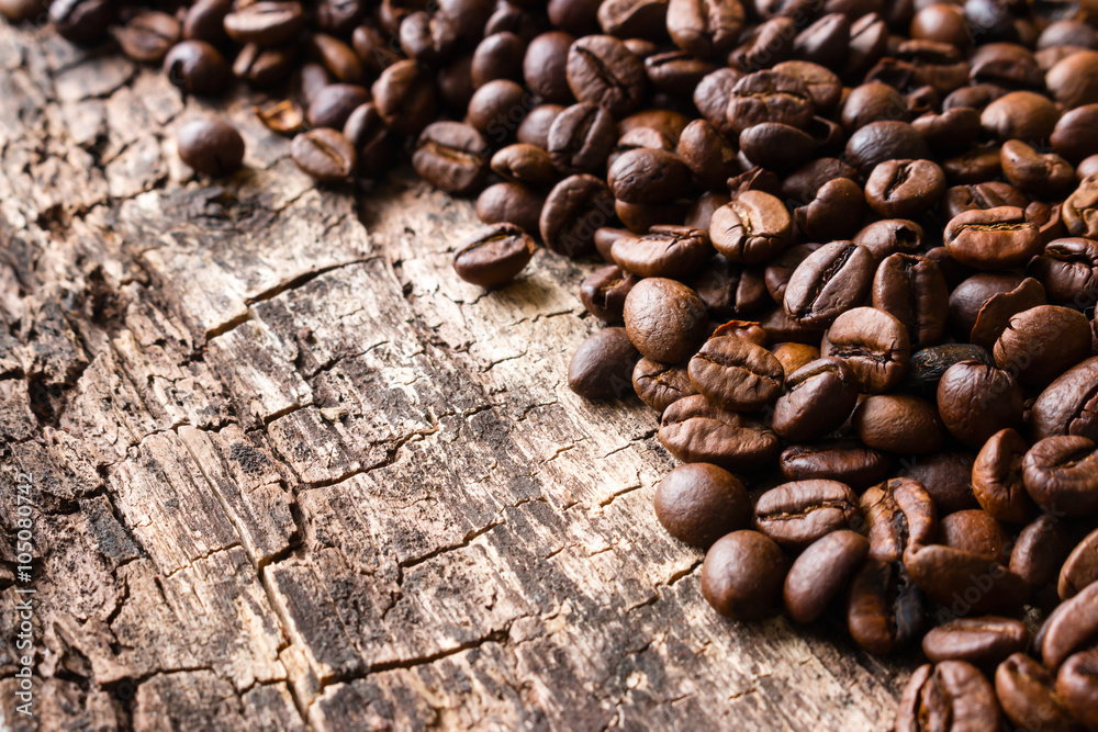 roasted coffee beans on a wooden background close up roasted coffee beans on a wooden background close up