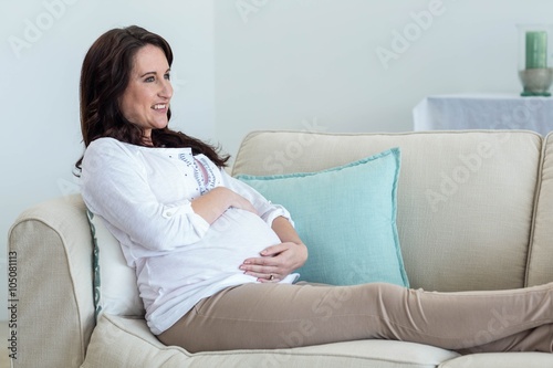 Pregnant woman resting on couch 