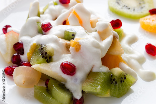 fresh fruit and ice cream on a white plate