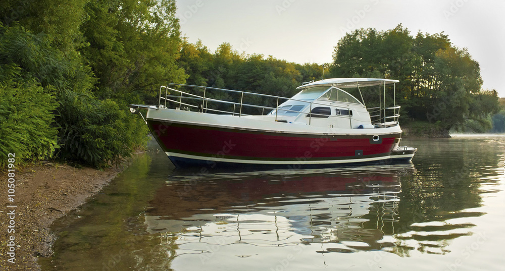 moored red and white yacht near sandy coast and trees moored red and white yacht near sandy coast and trees
