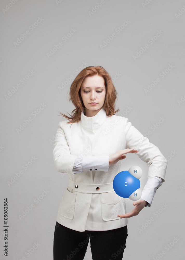 Young woman scientist with model of water molecule. Young woman scientist with model of water molecule.