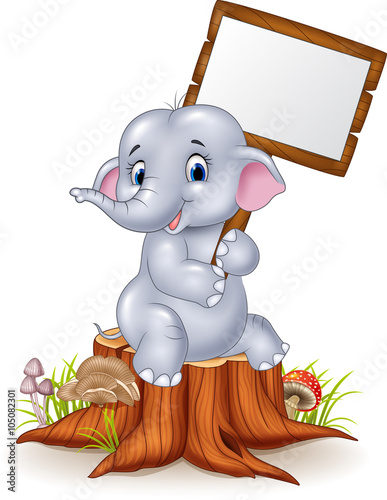 Cute baby elephant holding blank sign on tree stump