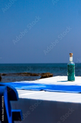 Tables with chairs in traditional Greek tavern in Kolympia town on coast of Rhodes island, Greece. photo