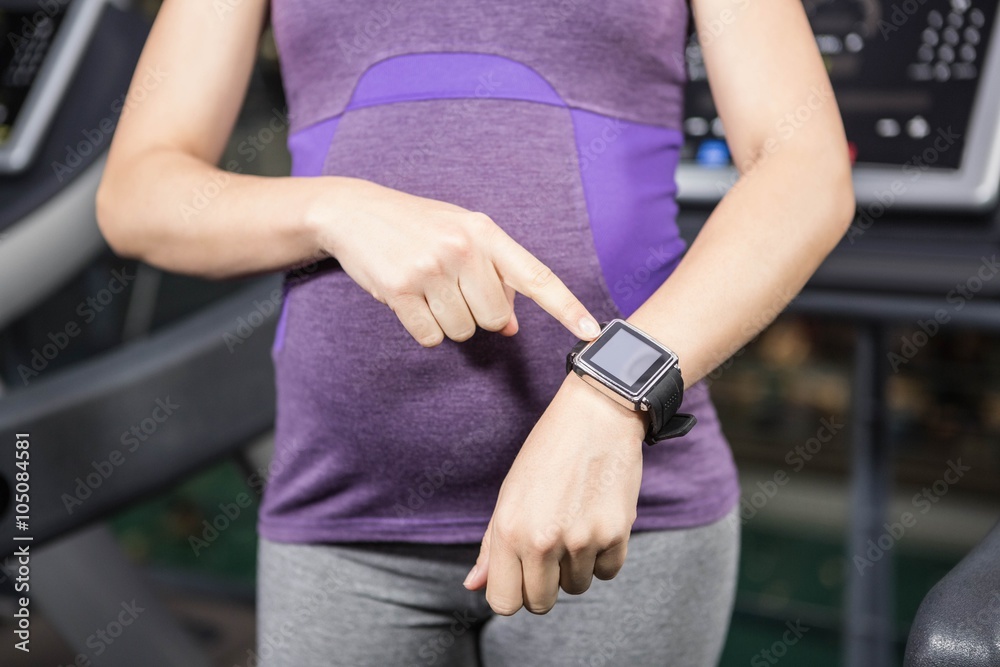 Pregnant woman pointing smart watch