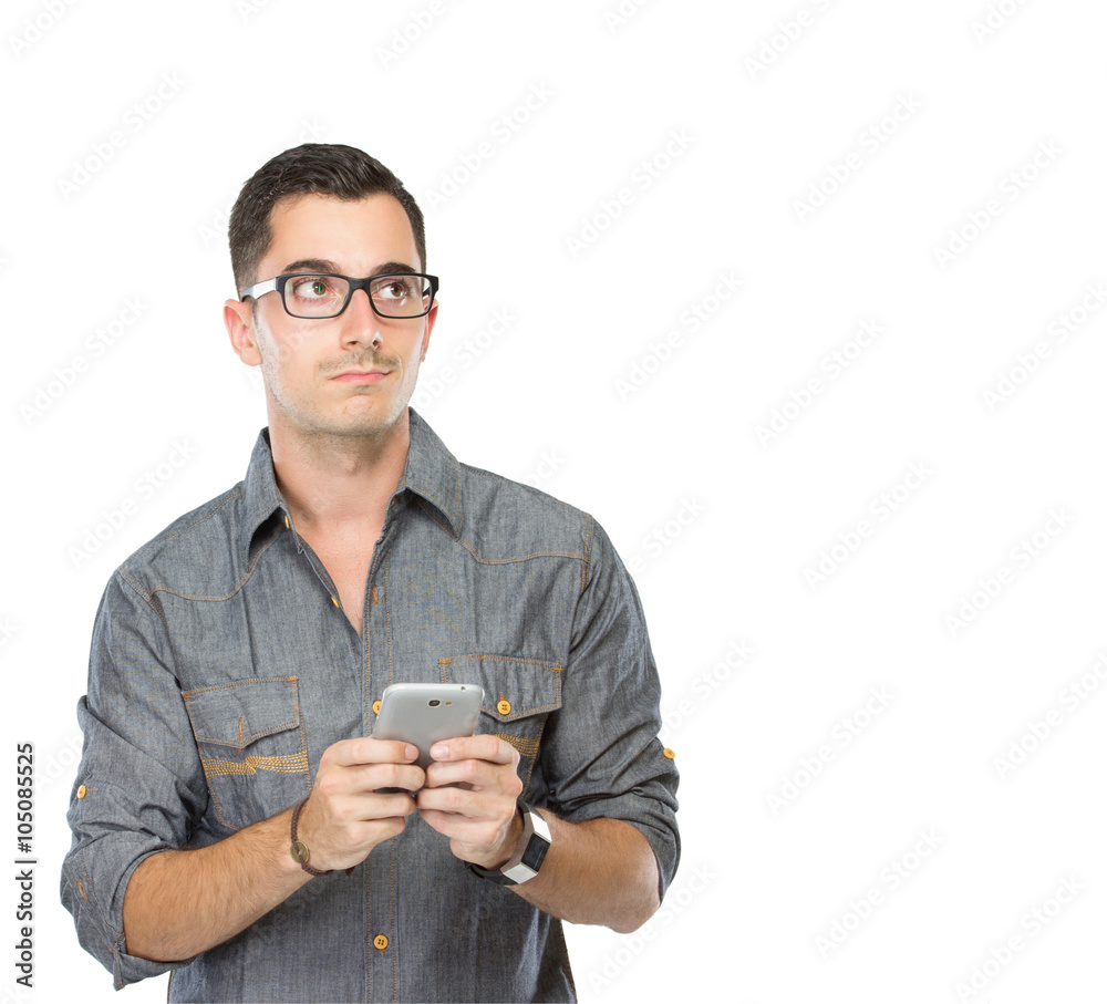 young man looking up while holding smartphone isolated young man looking up while holding smartphone isolated