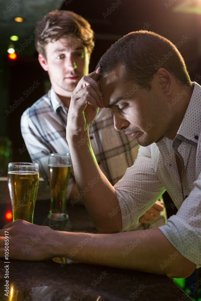 Man comforting his depressed friend Man comforting his depressed friend