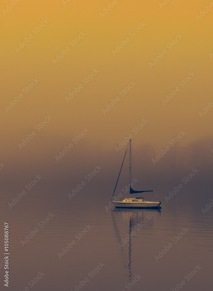 Boat on foggy lake windermere