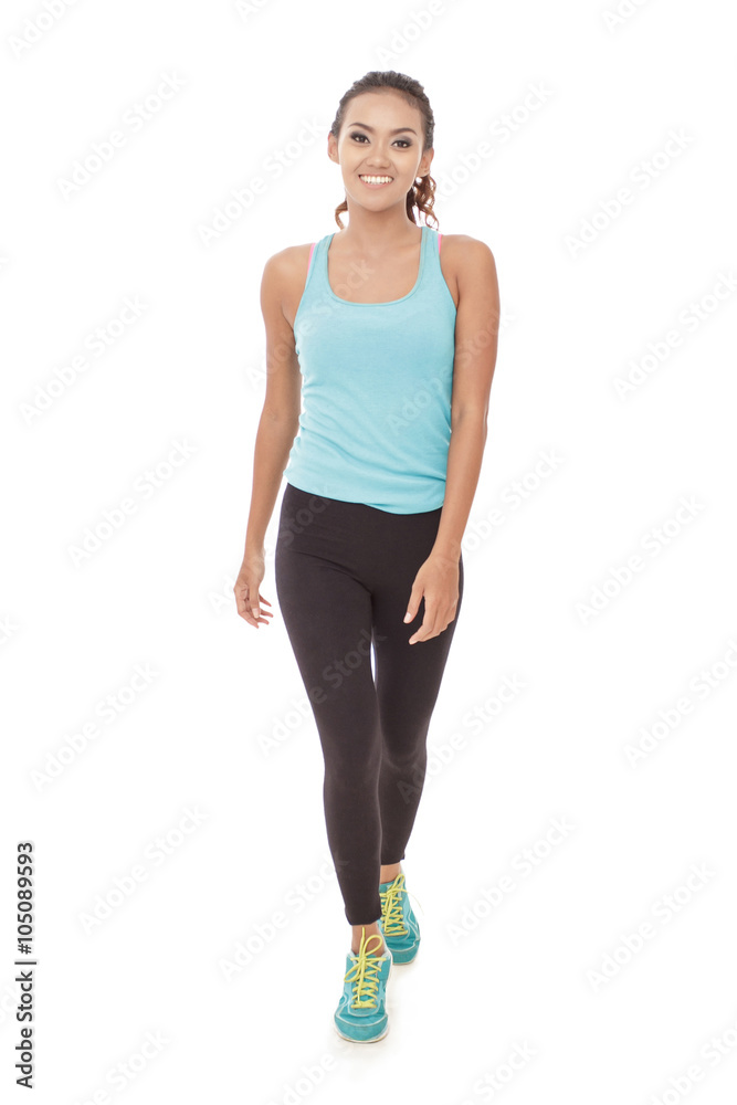 sporty styles woman in walking pose while smiling sporty styles woman in walking pose while smiling