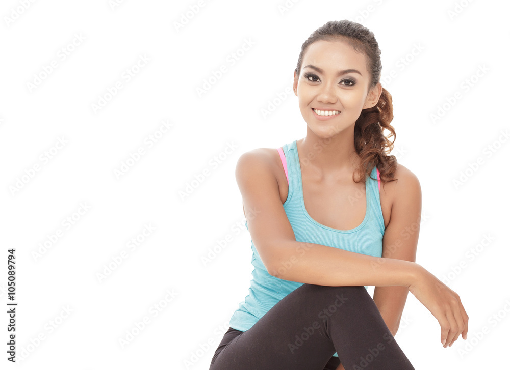 young sporty woman smiling while sitting young sporty woman smiling while sitting