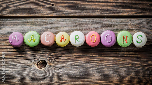 Tasty words of macaroons on wooden table