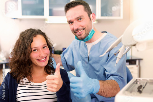 Young attractive woman being cured by a dentist