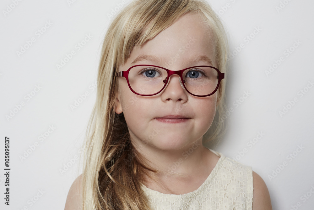 Cute little girl in glasses looking at camera Cute little girl in glasses looking at camera