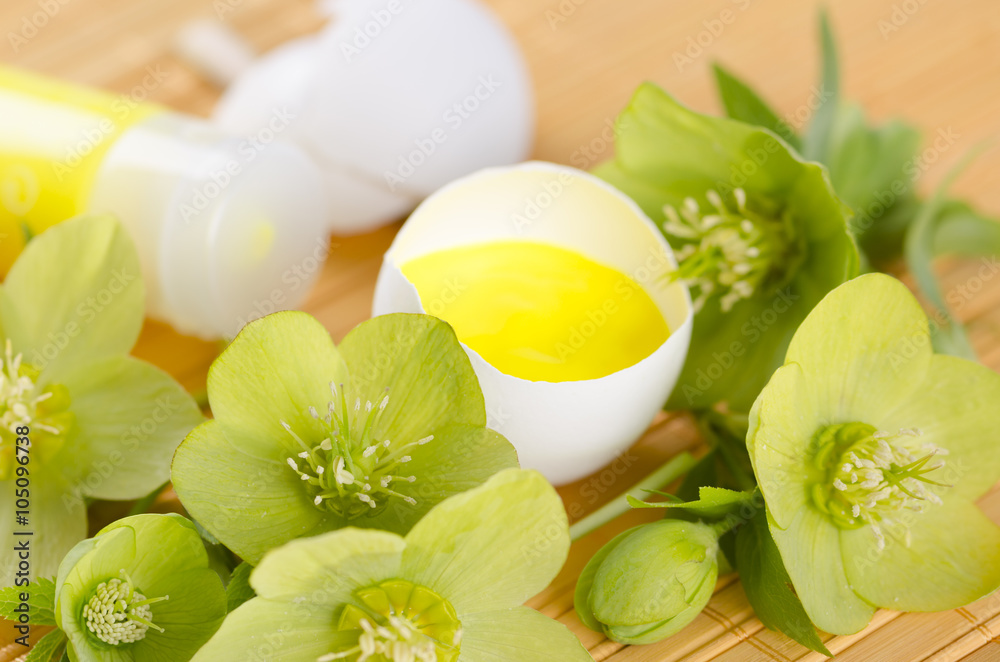 Happy Easter decoration with spring flowers and egg shell on a yellow pad Happy Easter decoration with spring flowers and egg shell on a yellow pad