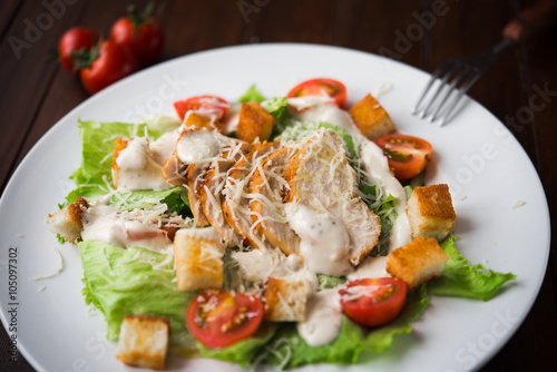 Caesar salad with chicken and tomato