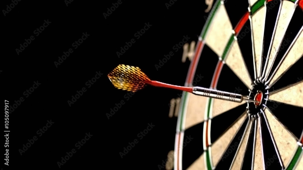 Dart hitting bull's eye, slow motion