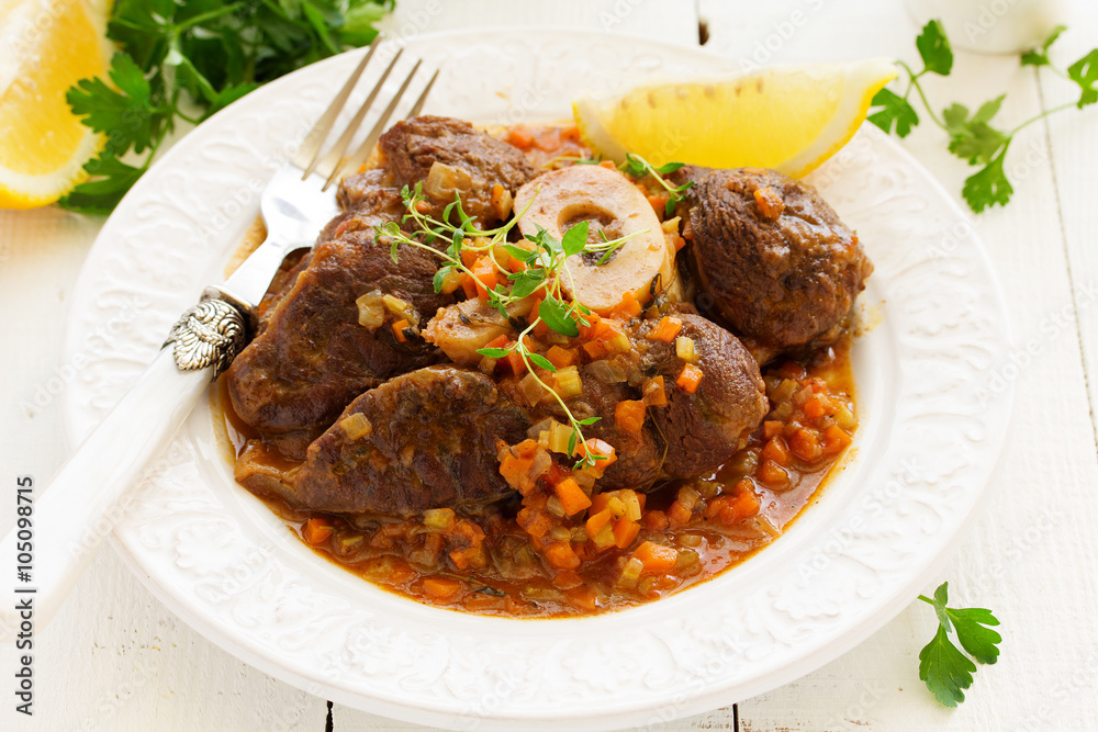 ossobuco with polenta on the Milanese. Italian Cuisine. ossobuco with polenta on the Milanese. Italian Cuisine.