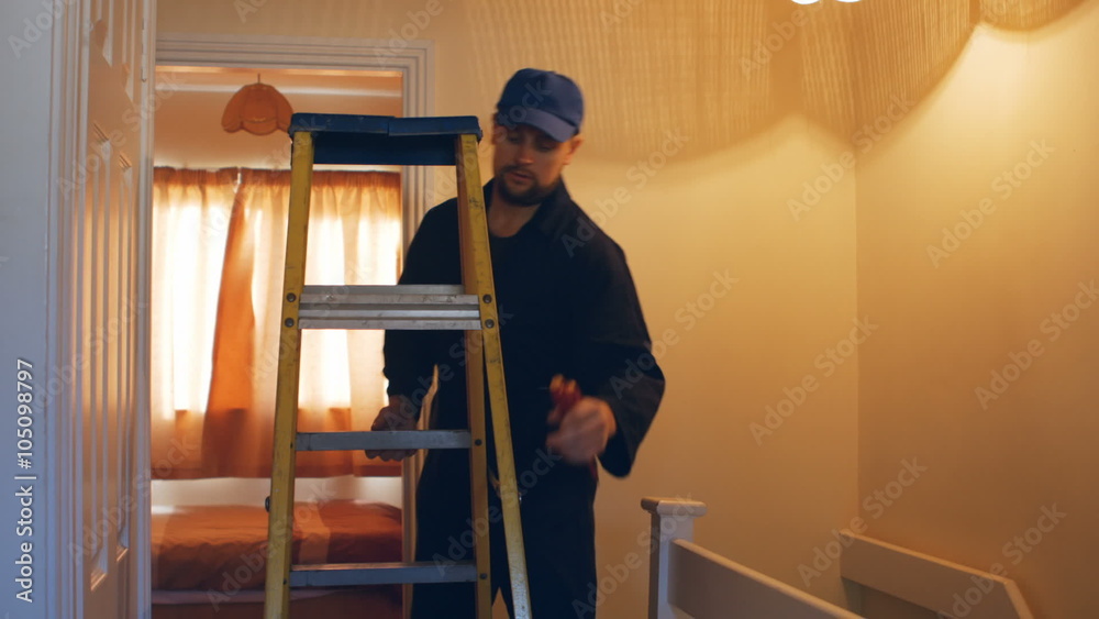 Man fixing the fire detector Man fixing the fire detector